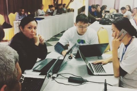 Participants in a workshop or conference at KG Labs Foundation, Bishkek, Kyrgyzstan, working on laptops and discussing digital transformation.