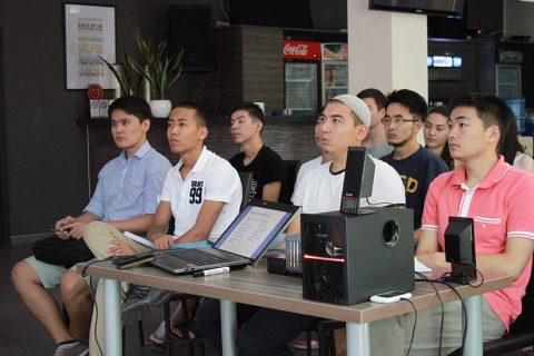 A group of young men attending a presentation on private equity and venture capital at a startup incubator in Bishkek, Kyrgyzstan.