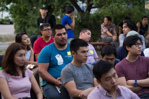 A group of people sitting together, possibly at an event or meeting.