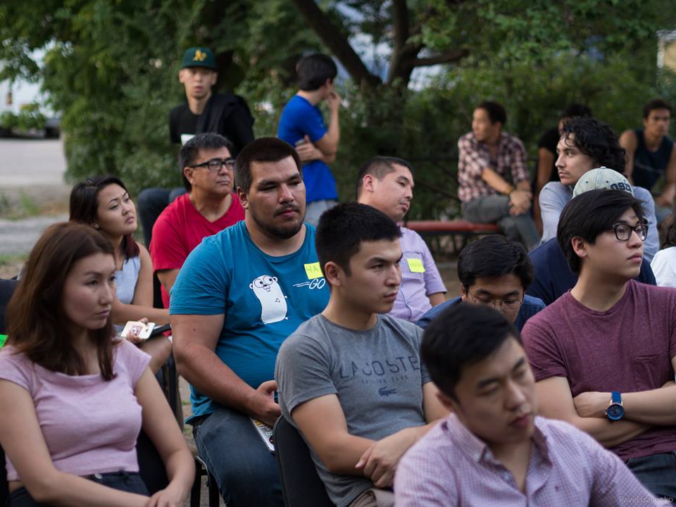 A group of people sitting together, possibly at an event or meeting.
