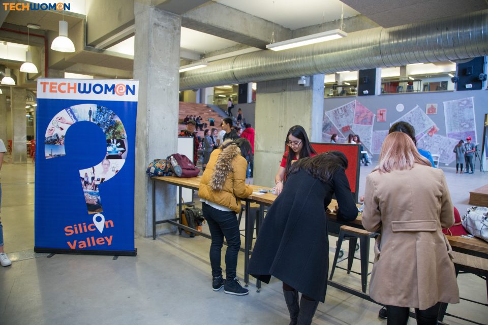 Participants at a TechWomen event in Silicon Valley, with a banner reading 'TechWomen: Silicon Valley'.