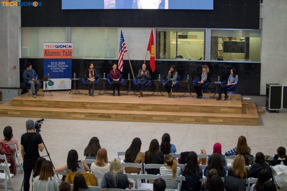 A panel discussion event with women speakers on stage in Bishkek, Kyrgyzstan.
