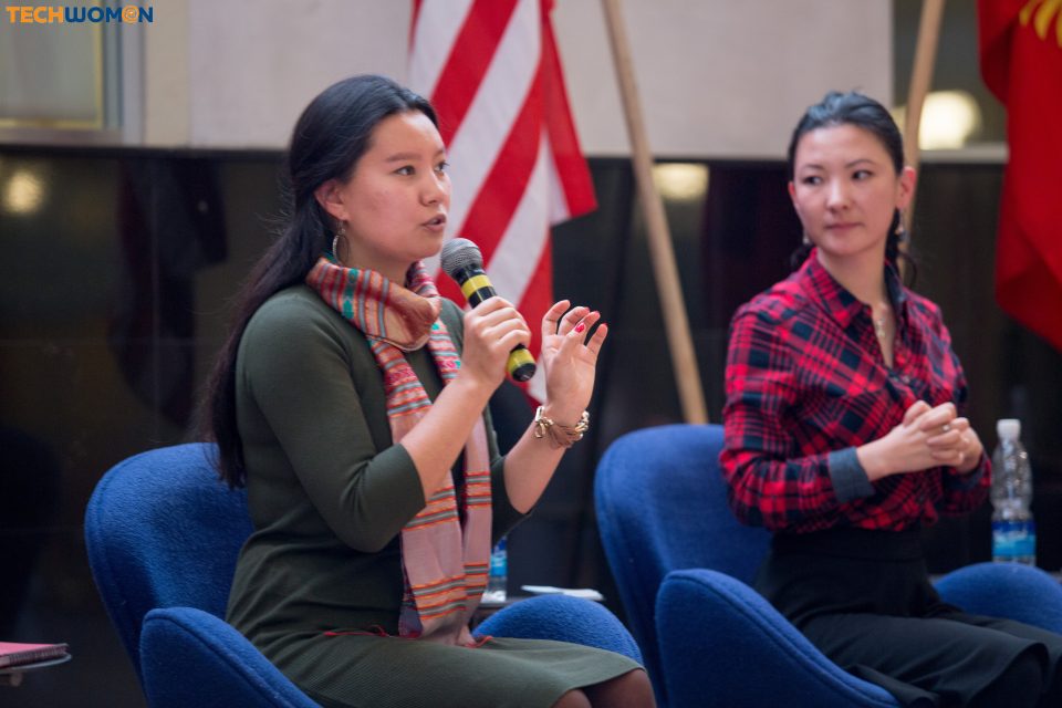 Two women participate in a discussion at a conference in Bishkek, Kyrgyzstan.