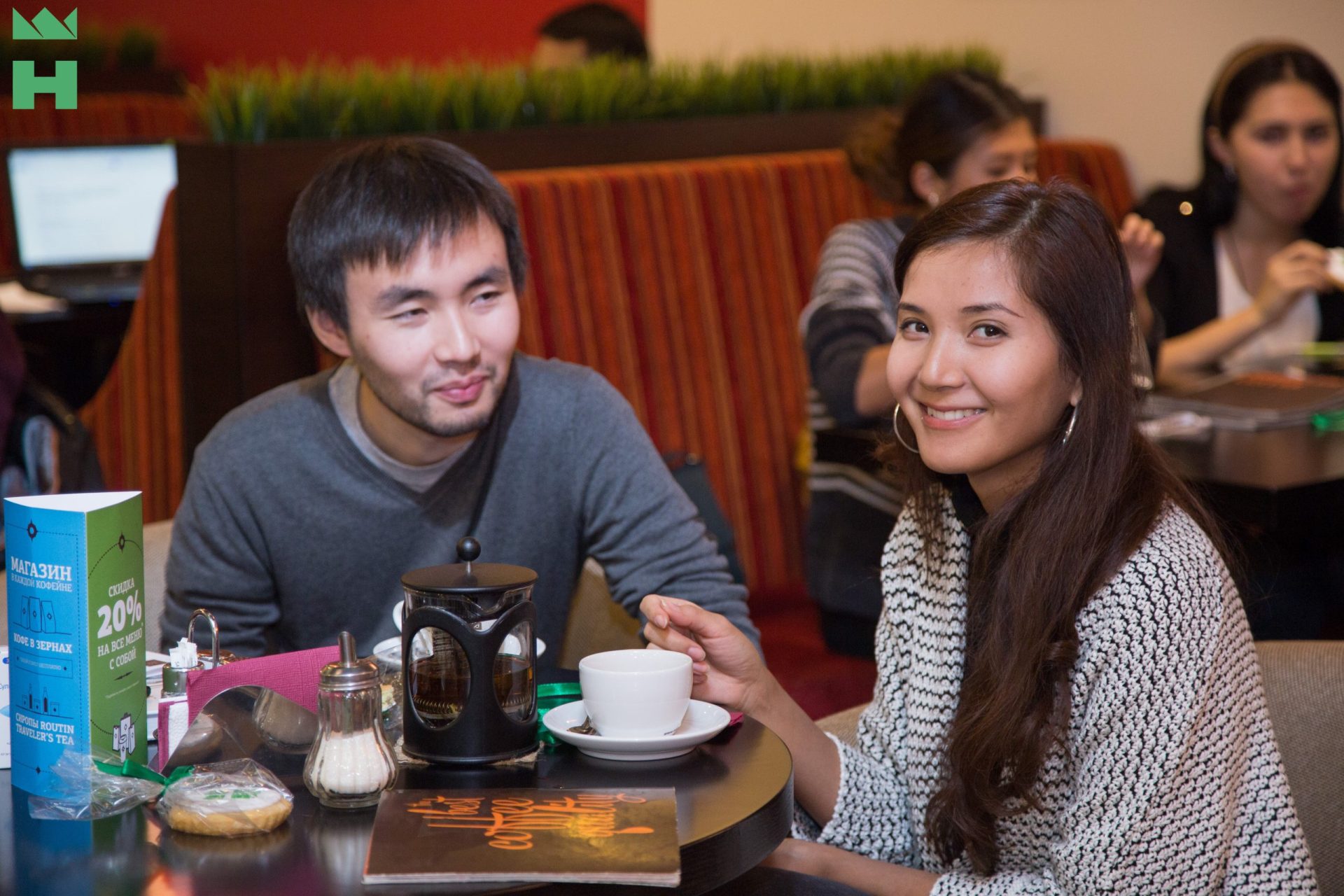 Two individuals enjoying a coffee at Traveler's Coffee in Bishkek, Kyrgyzstan.