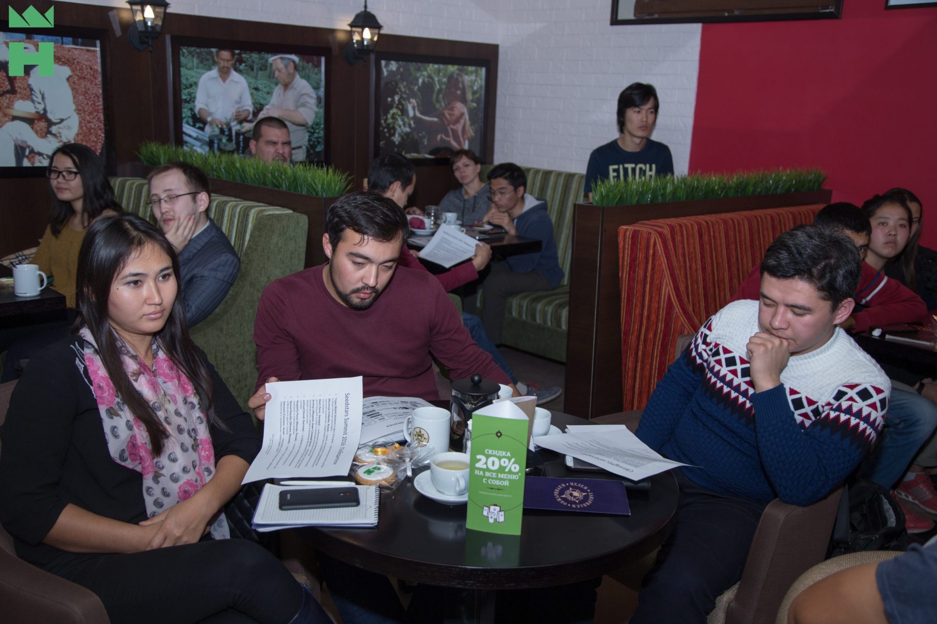 Participants in a workshop or meeting at a cafe in Bishkek, Kyrgyzstan.