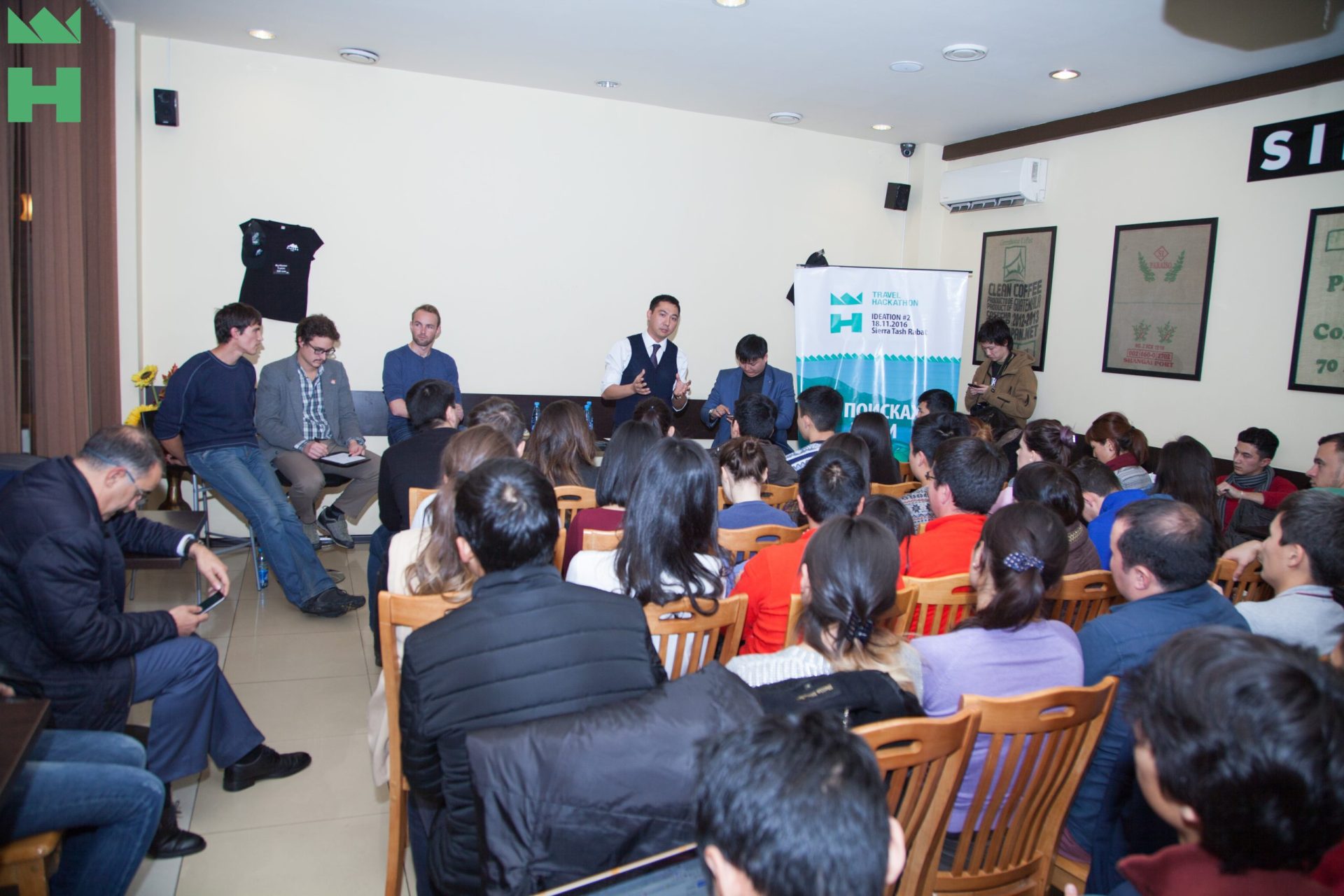 A group of people sitting in a room, engaged in a discussion or workshop.