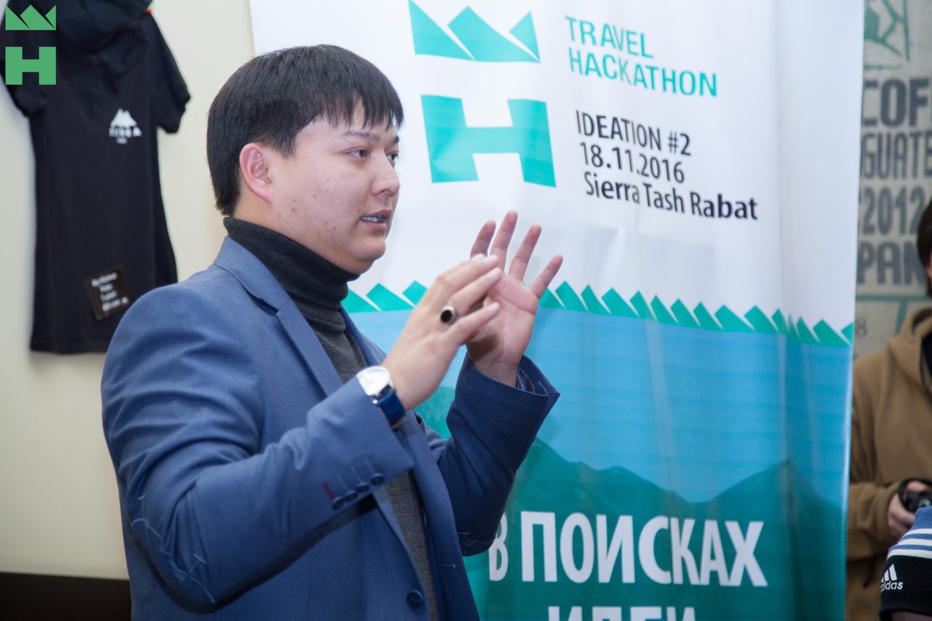 A person giving a presentation at a Travel Hackathon event in Bishkek, Kyrgyzstan.