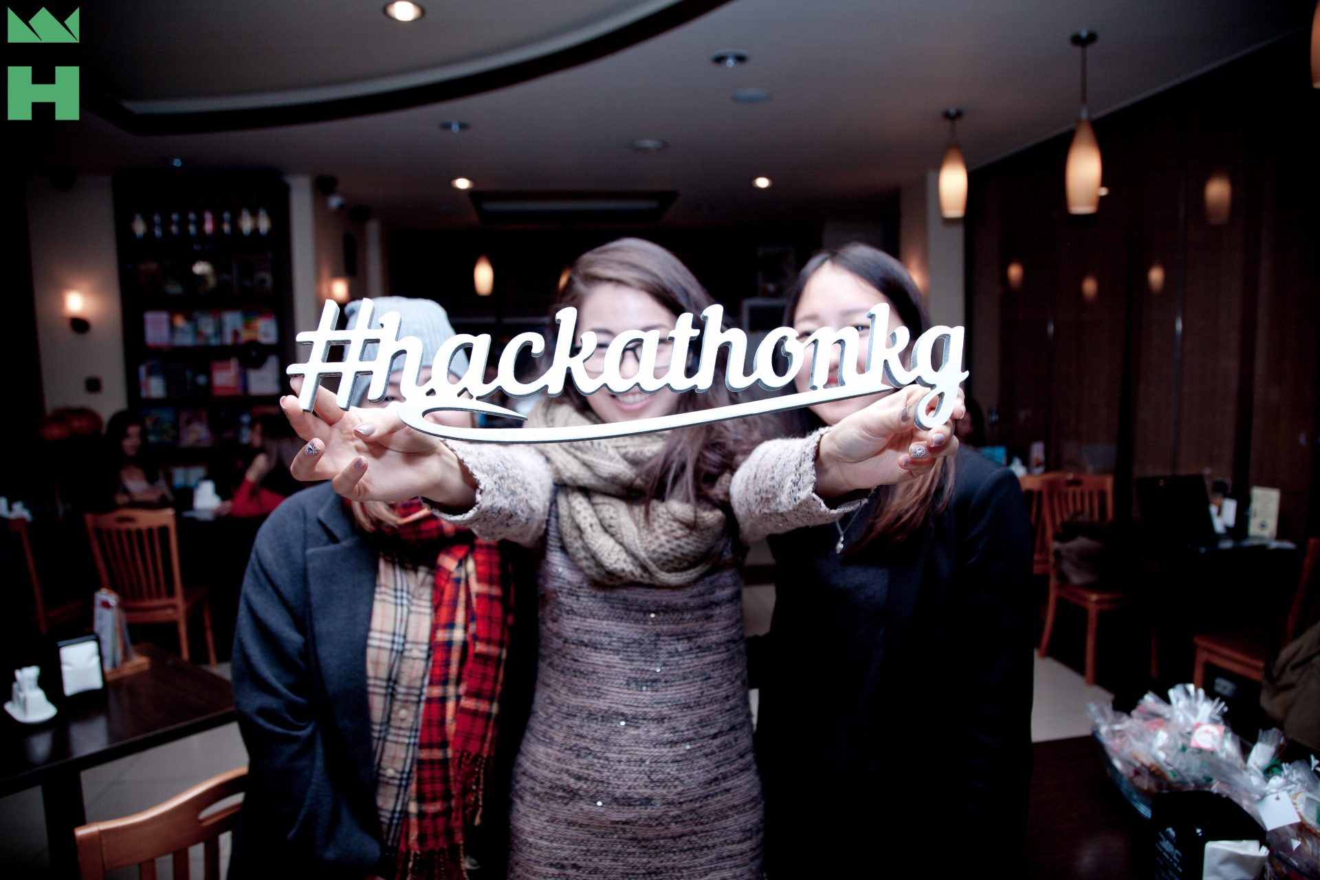 Participants holding a sign that reads '#hackathonkg' at an event in Bishkek, Kyrgyzstan.