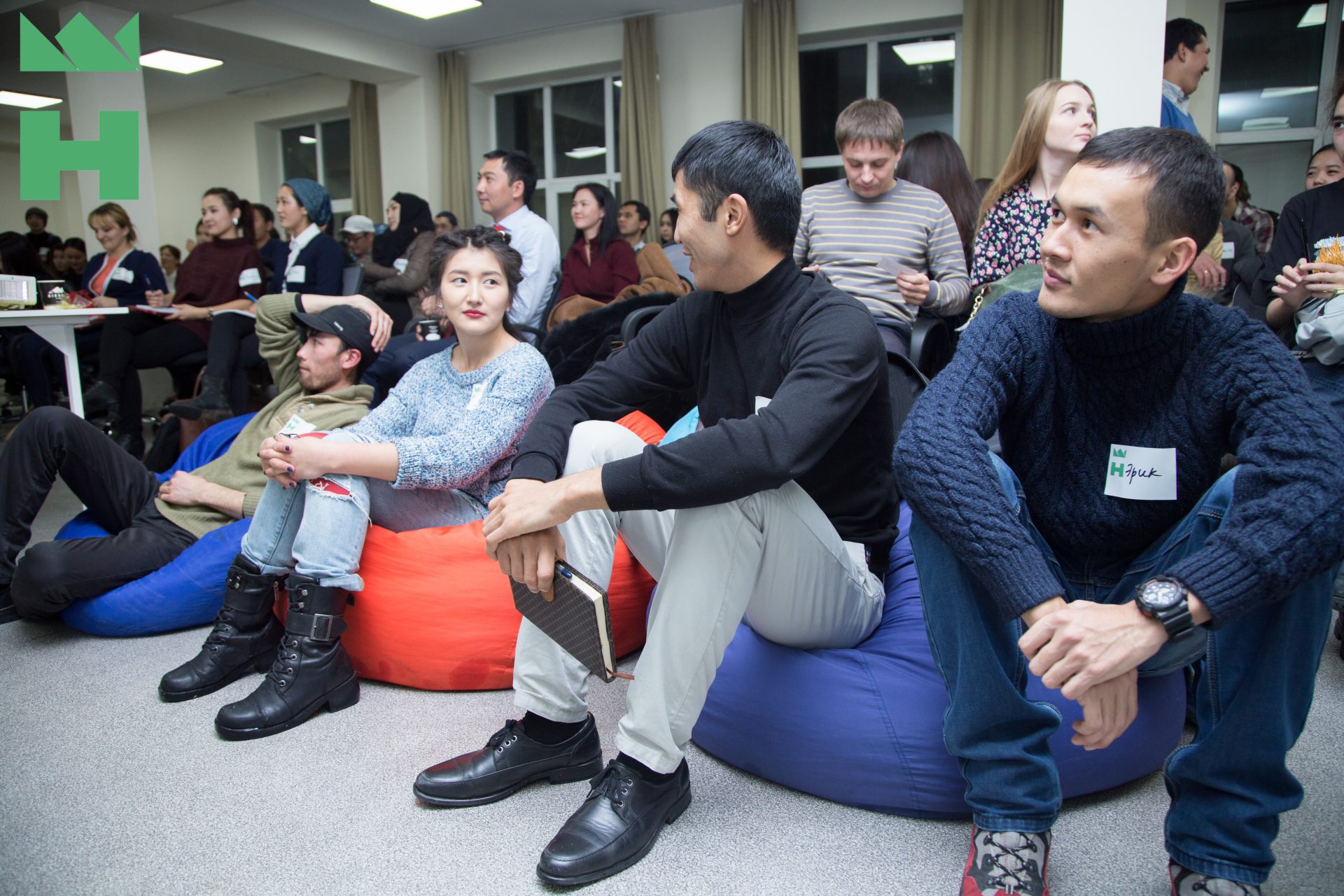 Participants seated on bean bags in a workshop setting at KG Labs Foundation in Bishkek, Kyrgyzstan.