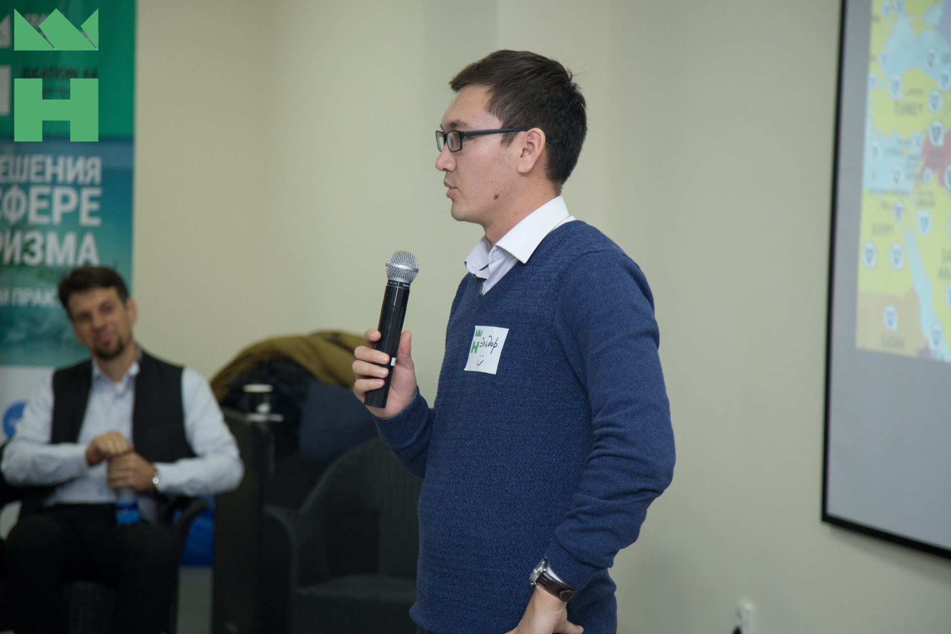 A person speaking at an event in Bishkek, Kyrgyzstan.