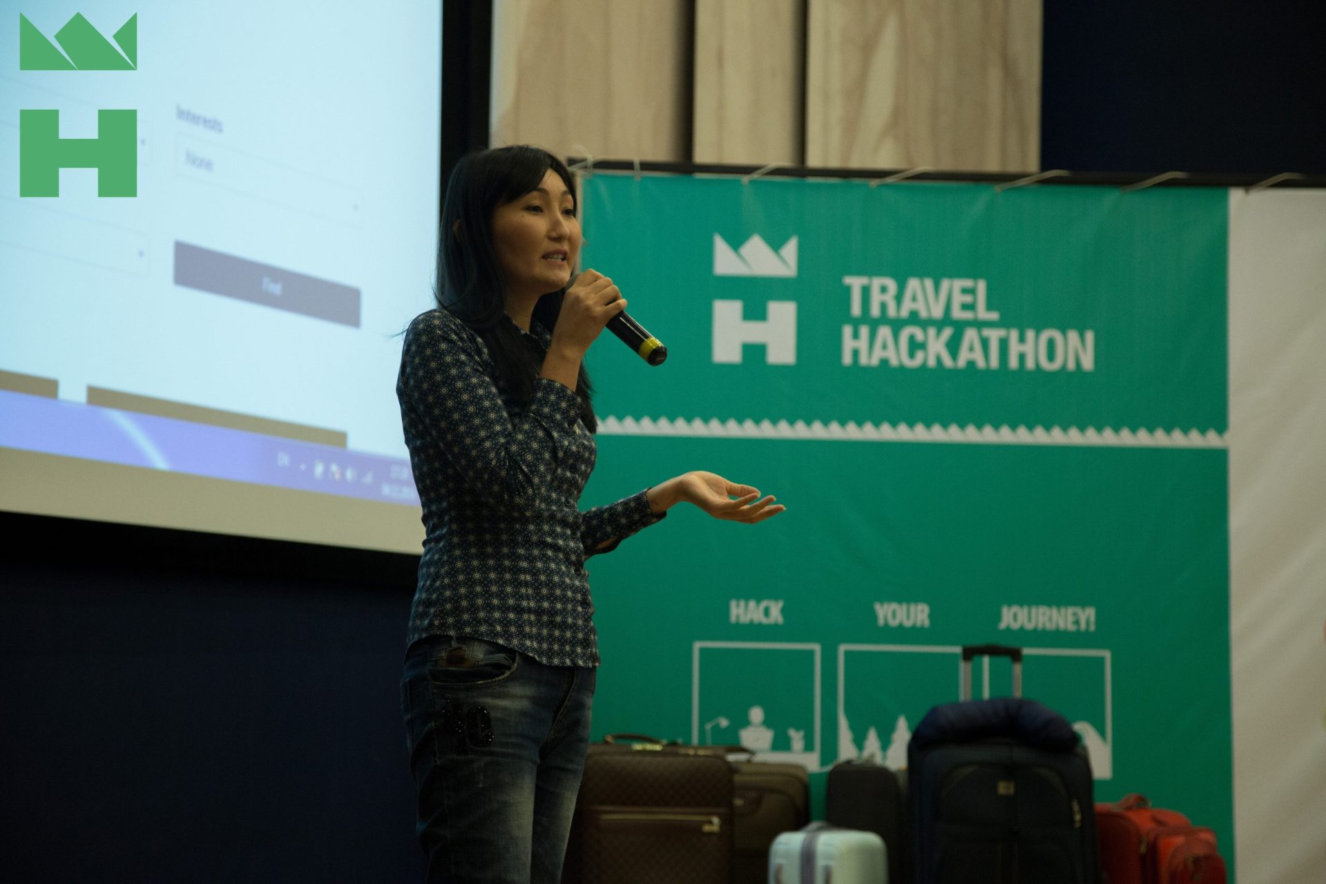 A person speaking at a Travel Hackathon event in Bishkek, Kyrgyzstan.