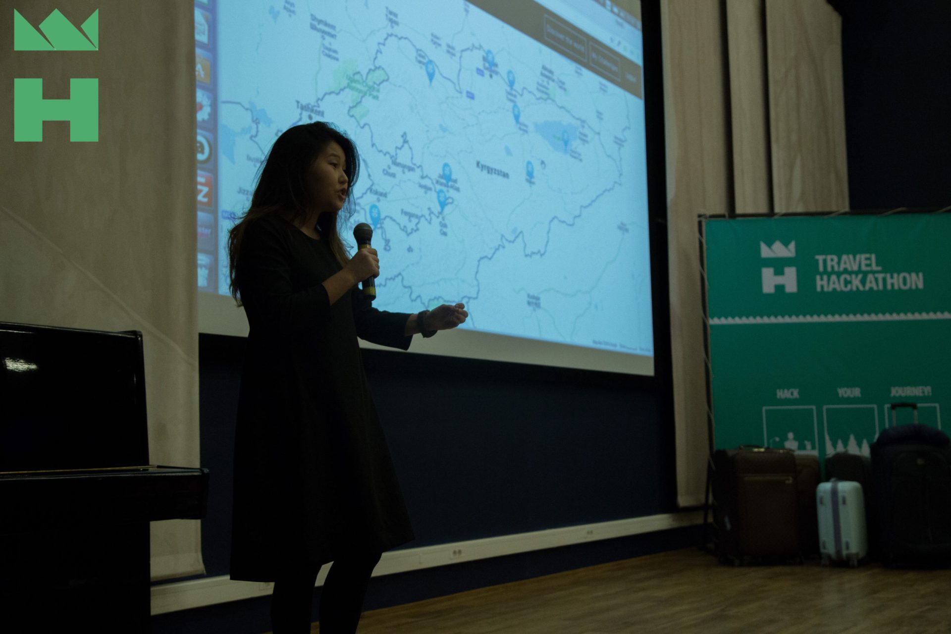 A person giving a presentation on a map at a Travel Hackathon event in Bishkek, Kyrgyzstan.
