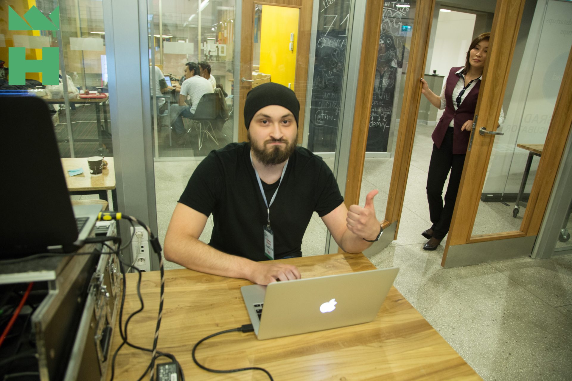 A person working on a laptop in a modern office setting.