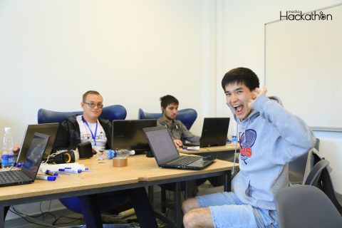 Participants at a media hackathon in Bishkek, Kyrgyzstan, with one person making a playful gesture.