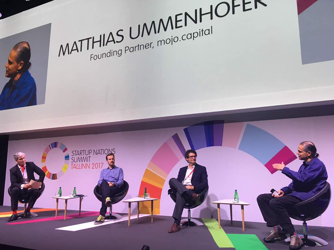 Four individuals seated on stage at the Startup Nations Summit 2017 in Tallinn, Estonia.