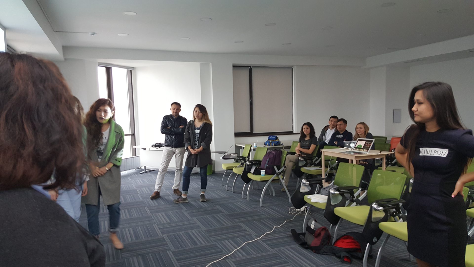 A group of people in a conference room, possibly participating in a workshop or training session.