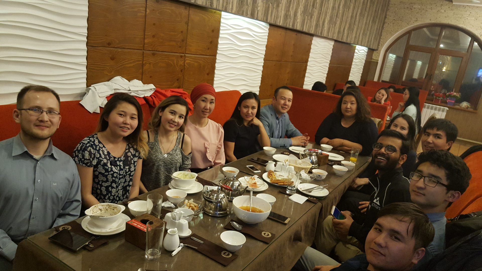 A group of people enjoying a meal together in a restaurant in Bishkek, Kyrgyzstan.