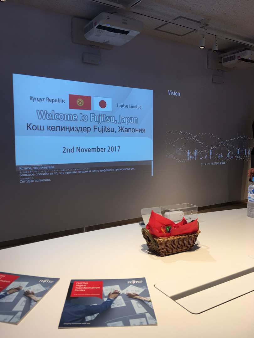 A presentation slide welcomes attendees to Fujitsu Digital Transformation Center in Japan.