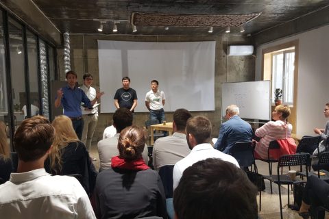 A group of people is gathered in a room for a meeting or presentation.