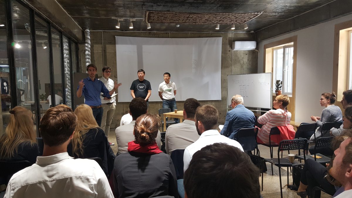 A group of people is gathered in a room for a meeting or presentation.