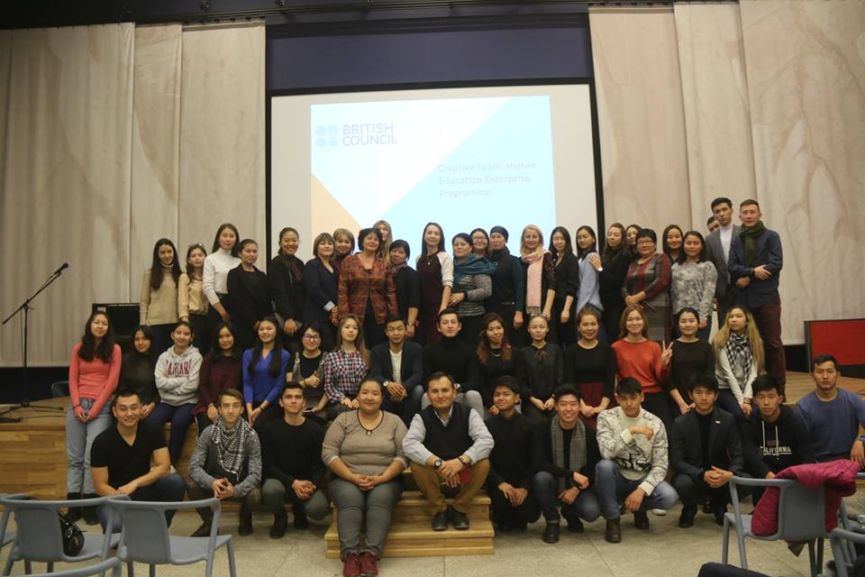 Group of people posing for a photo in a conference setting.