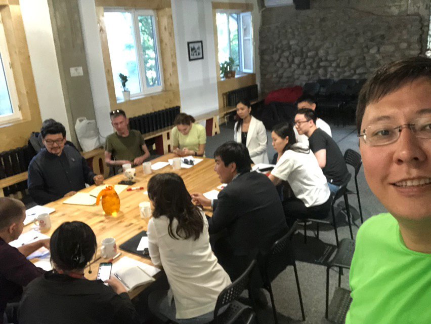 A group of people engaged in a discussion at a conference table in Bishkek, Kyrgyzstan.