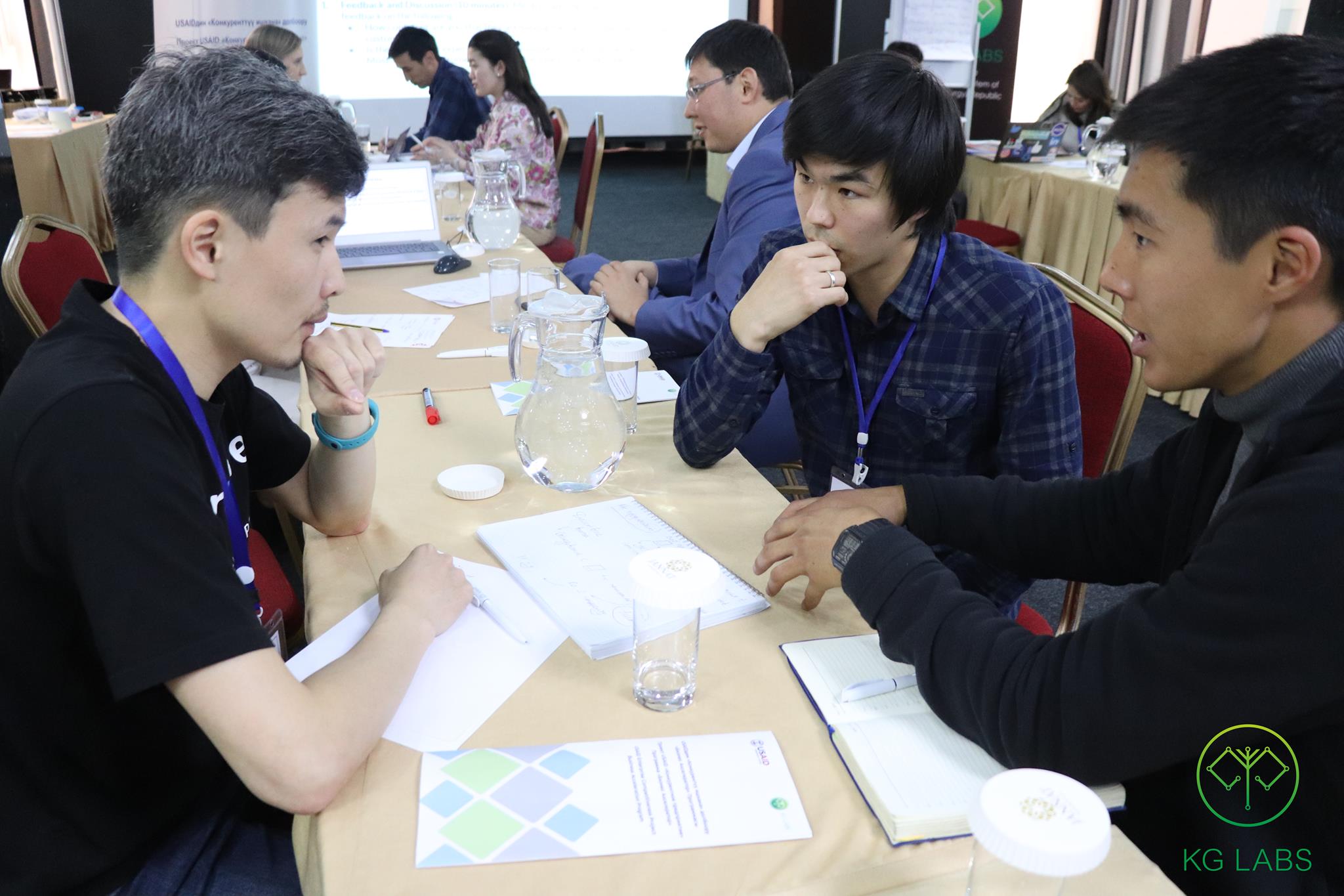 Participants in a workshop at KG Labs Foundation, Bishkek, Kyrgyzstan, discussing project ideas with mentors.